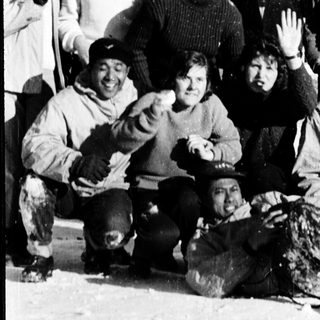 Group of people posing outdoors in winter clothing.