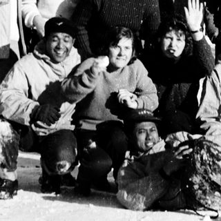 Group of people posing outdoors in winter clothing.