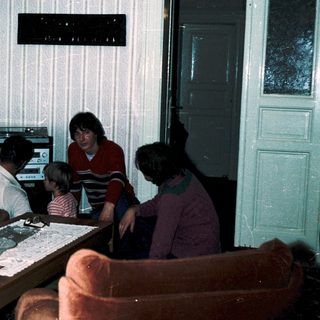 Family playing video game together in living room.