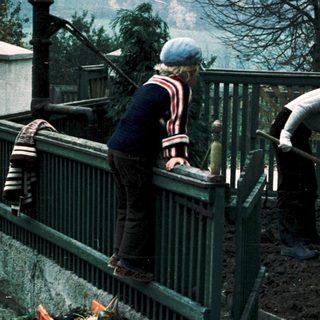 Two men gardening on elevated dirt bed.