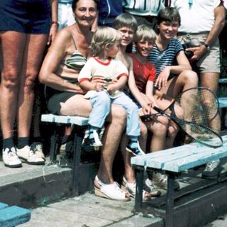 Family group photo outdoors in summer attire.