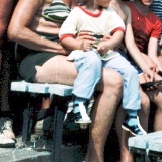Family group photo outdoors in summer attire.