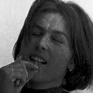 A person eating while smiling.