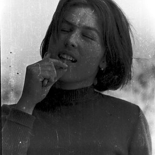 A person eating while smiling.