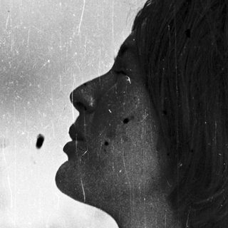 Portrait of a person with short hair, side profile.