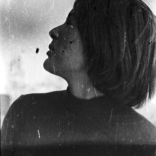 Portrait of a person with short hair, side profile.
