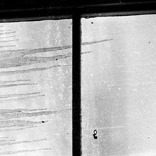 Rain streaks on a window pane.