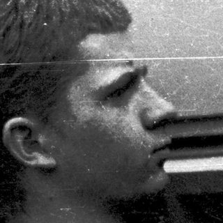 A person taking a self-portrait with a vintage twin-lens reflex camera.