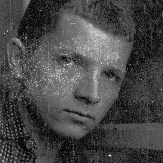 Vintage-style portrait with raindrops on glass.