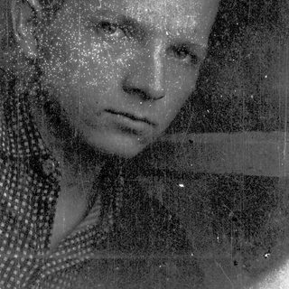 Vintage-style portrait with raindrops on glass.