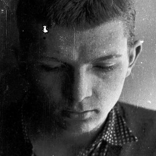 Young person looking downward, possibly contemplative.