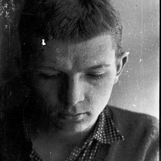 Young person looking downward, possibly contemplative.