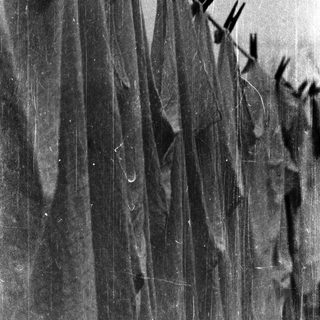 Clothes hanging on wet outdoor lines.