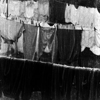 Clothes hanging on a line in rain.