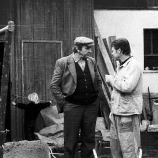 Two men inspecting construction materials at a building site.