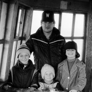 Family posing together outdoors in winter attire.