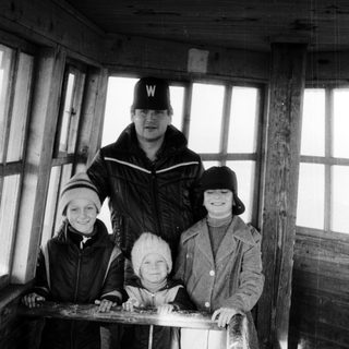 Family posing together outdoors in winter attire.