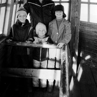 Family posing together outdoors in winter attire.