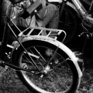 Five children with bicycles in a backyard.
