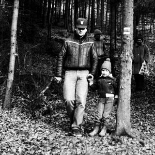 Family hiking in a forested trail.