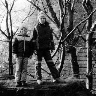 Two people standing outdoors in winter attire.