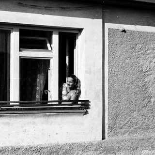 Woman leaning out of a window.