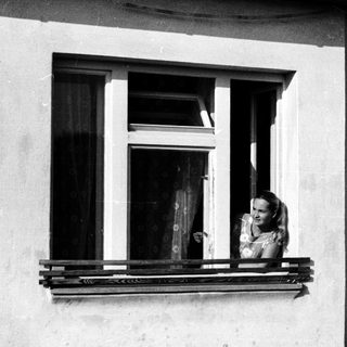 Woman leaning out of a window.