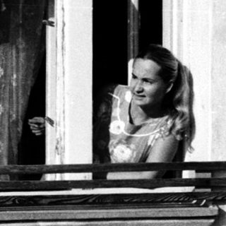 Woman leaning out of a window.