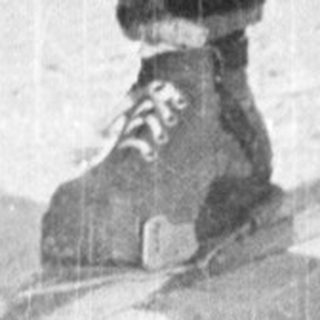 Person cross-country skiing outdoors in winter attire.