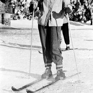 Person cross-country skiing outdoors in winter attire.
