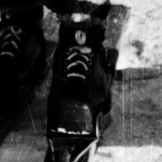 Ski racer bending forward in competitive downhill skiing.