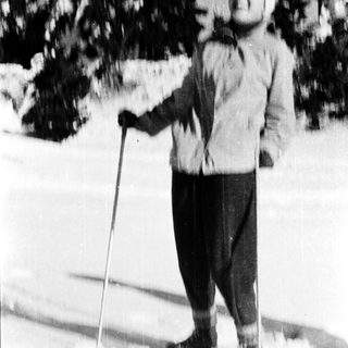 Person cross-country skiing in snowy outdoor setting.