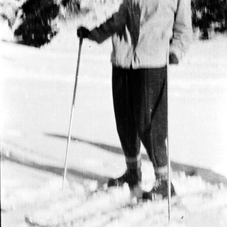 Person cross-country skiing in snowy outdoor setting.