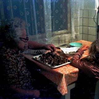 Family preparing food together in a kitchen.