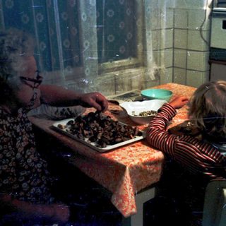 Family preparing food together in a kitchen.