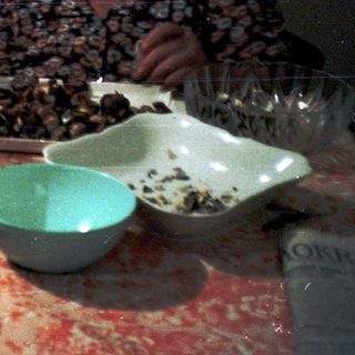 Two children and an adult preparing food together.