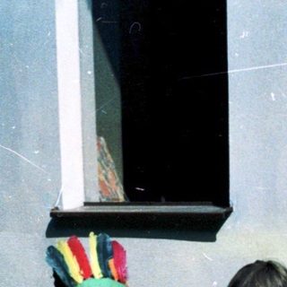 Two children playing outside with a board game.