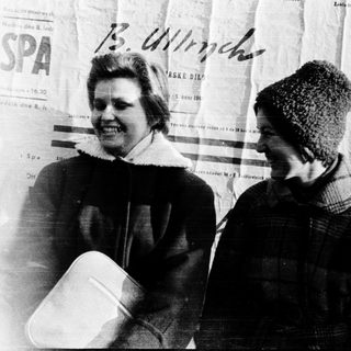 Two women standing together outdoors in winter clothing.