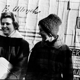 Two women standing together outdoors in winter clothing.