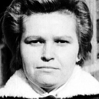 Black-and-white portrait of a woman in winter coat.