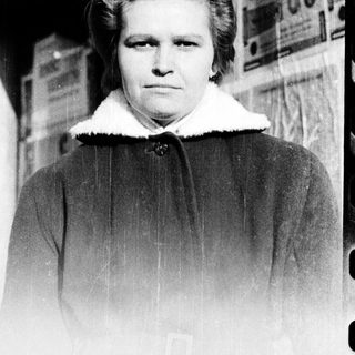 Black-and-white portrait of a woman in winter coat.