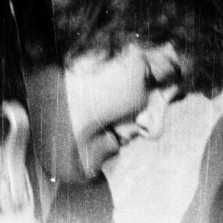 Two women laughing in a mirror.