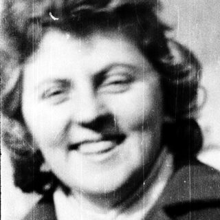 Smiling woman in vintage clothing, mid-20th century.