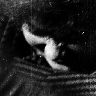 Blurred close-up of person smoking pipe.