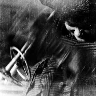 Blurred close-up of person smoking pipe.