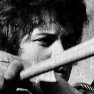 Person playing violin with intense focus.