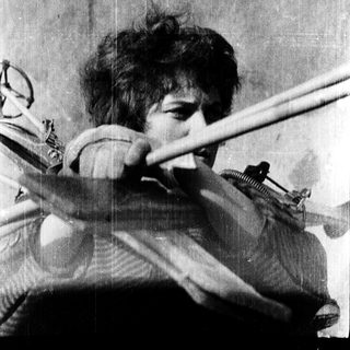 Person playing violin with intense focus.