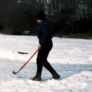 People playing ice hockey on a frozen field.