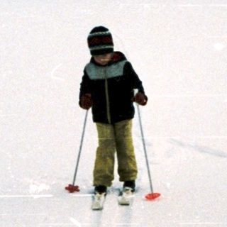 Person cross-country skiing on snow-covered field.