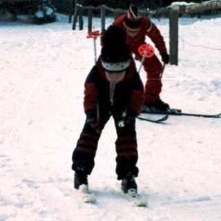 People skiing on snow-covered slope.